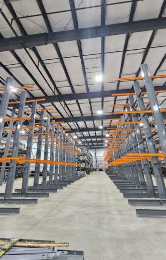 Long rows of four-level cantilever racking with orange arms for staging trusses